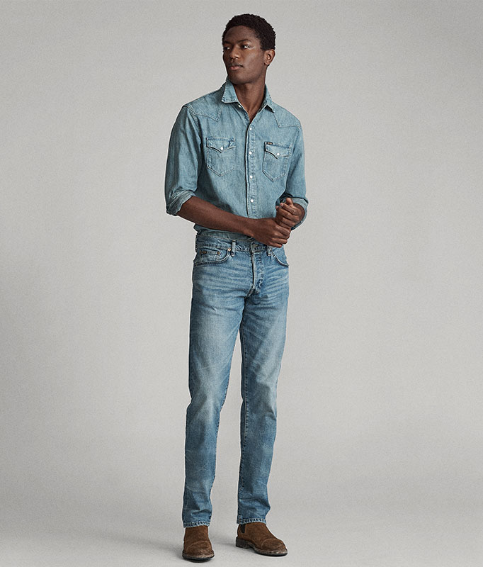 Man in chambray shirt & medium-wash straight jeans
