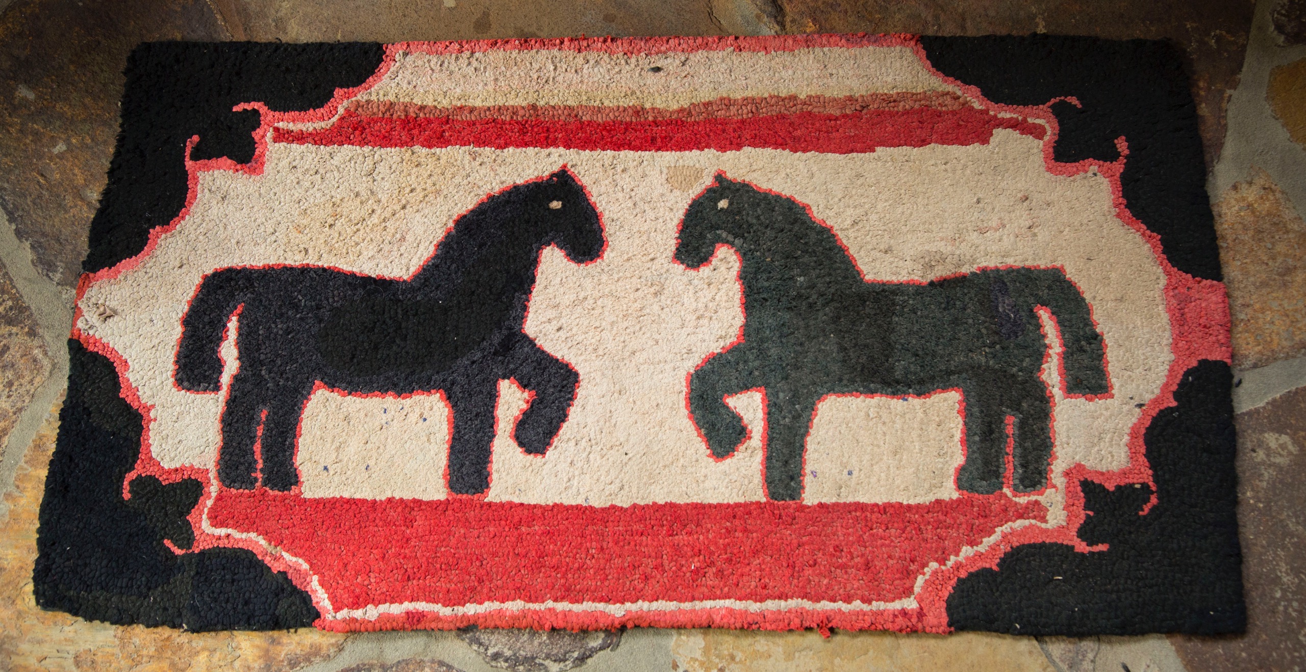 Early rag rugs like this one of a horse-to-horse greeting are better preserved as wall hangings rather than displayed underfoot
