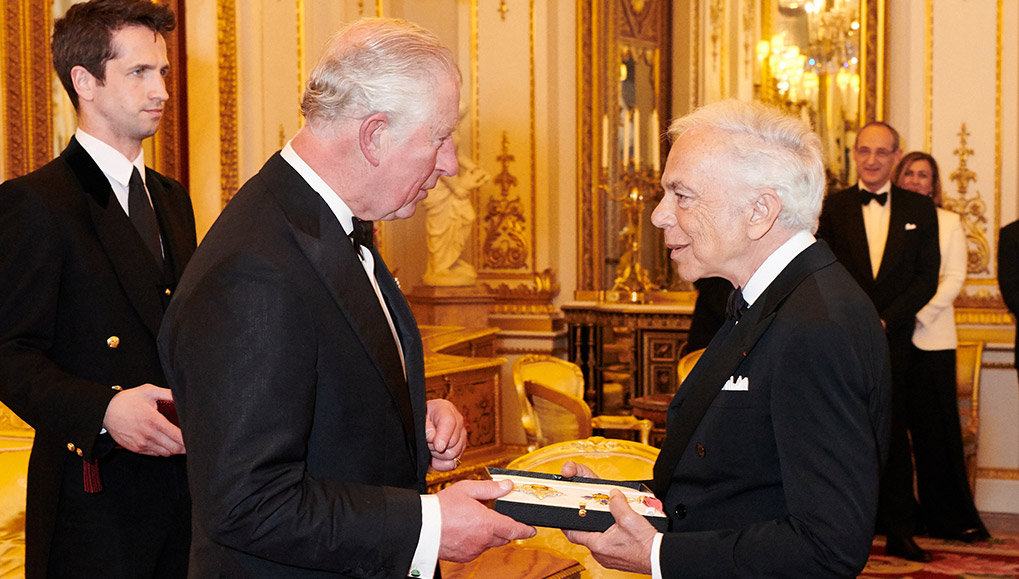 Ralph Lauren being presented with the knighthood insignia at Buckingham Palace