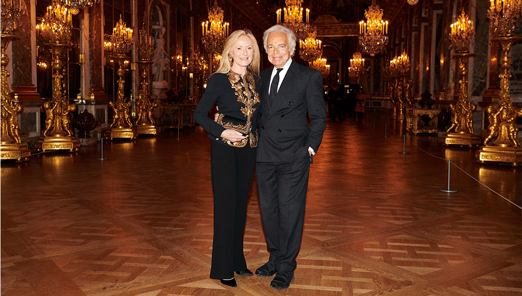 Ricky and Ralph Lauren in formal attire in Versailles ballroom.